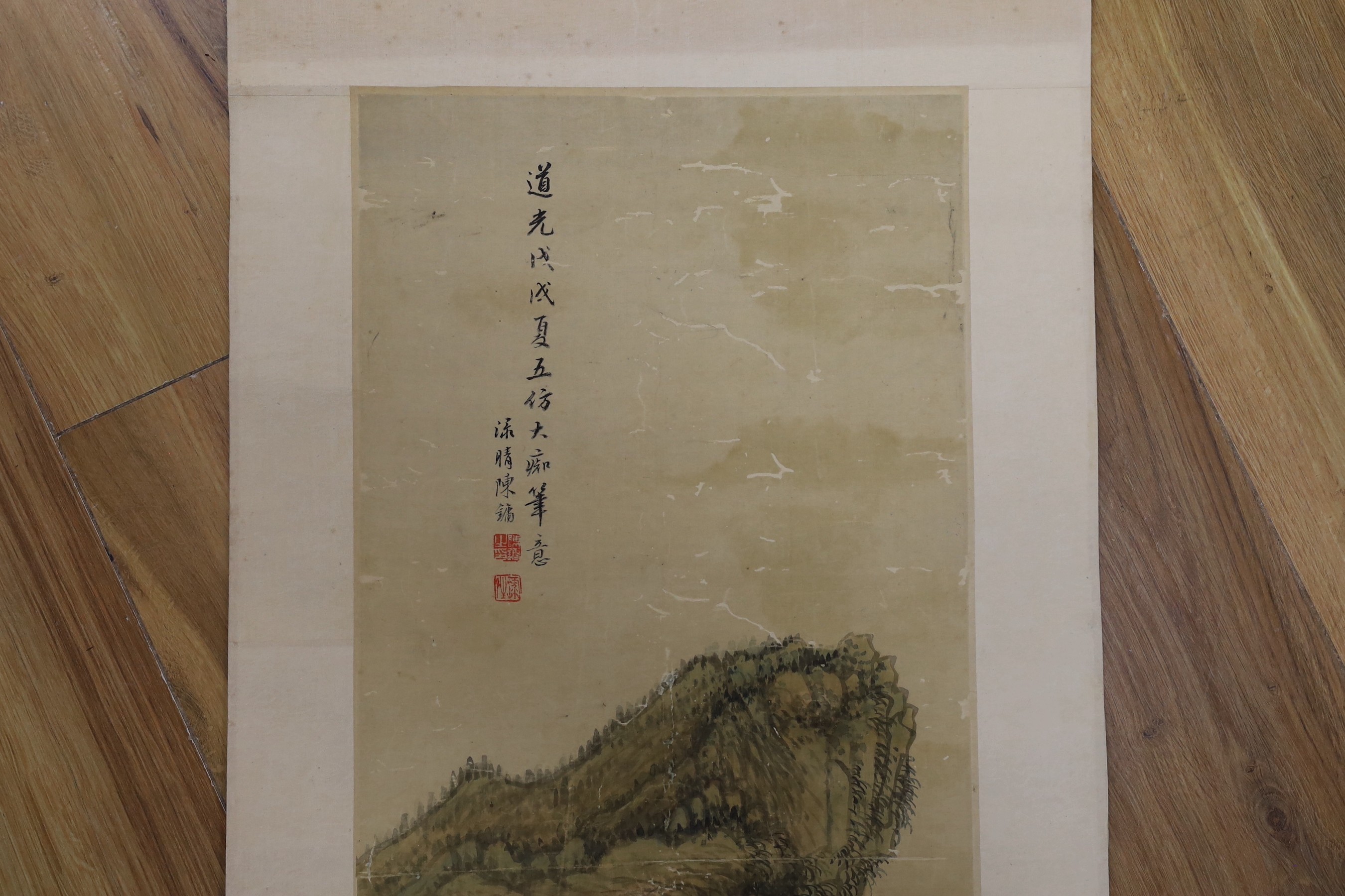 A Chinese landscape scroll painting on silk, Qing dynasty inscribed and signed, artist’s seal and collector’s seal lower left, image 139cm x 27.5cm, remounted